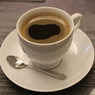 a cup of coffee on a saucer