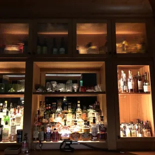 a bar with a lot of bottles on the shelves