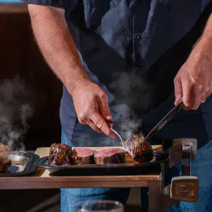 a man cooking steak
