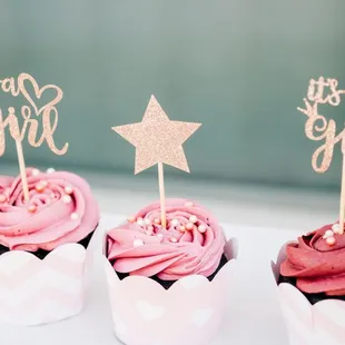 three cupcakes with pink frosting