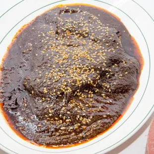 a bowl of sauce and a plate of rice