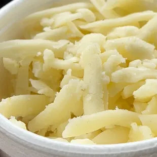 a bowl of shredded cheese