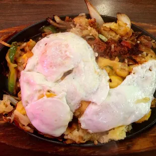 Sizzling breakfast parillada with chorizo, American, hash browns, onions, and bell peppers