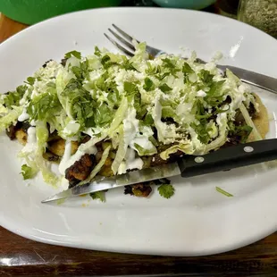 Not sure what this is called but it was a thick crispy corn tortilla bottom with grilled cactus, onion beans and lettuce.