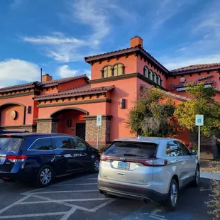 two cars parked in front of a building