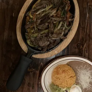 Beef fajitas with rice beans and toppings