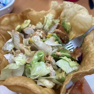 Chicken taco salad. Chicken is seasoned well. She&apos;ll is crispy and fresh.