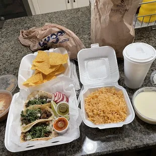 Street tacos Lengua and Tripe, beans, Spanish rice, queso and chips, and Jorchata