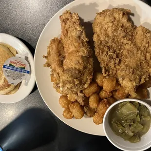 a plate of fried chicken with a side of pickles