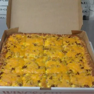 Breakfast pizza with eggs, sausage, and ham