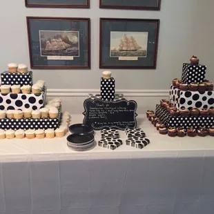 a table with a cake and cupcakes