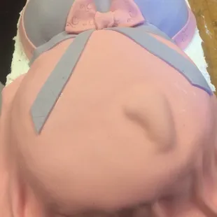 a cake shaped like a pregnant