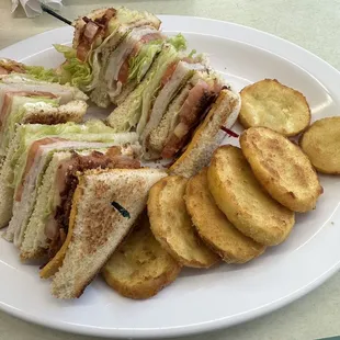 Club sandwich with fried squash on the side.