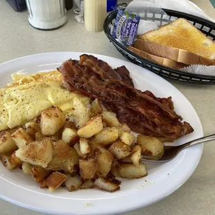 2 eggs scrambled w/ cheese, double order of bacon extra crispy, home-fried-potatoes, and toast.