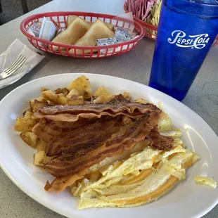 2 eggs scrambled w/ cheese, double order of bacon extra crispy, home-fried-potatoes, and toast.