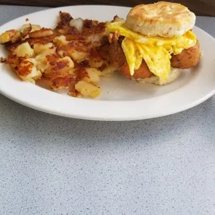 Fried chicken and biscuit with cheese, egg and homefries.