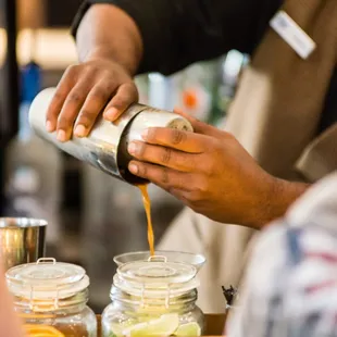 a bartender pouring a drink