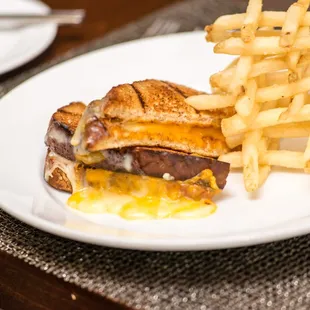 a grilled cheeseburger and fries