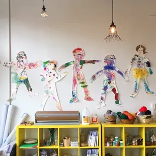 Children's artwork is proudly displayed throughout the studio.