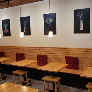 a row of tables and stools in a restaurant