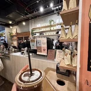 a hand holding a cup of coffee