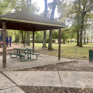 Pavilion with picnic table and 1 of 2 trashcans