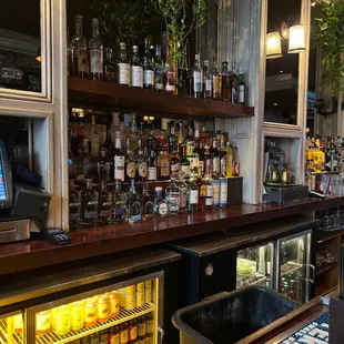 a bar with a lot of bottles of alcohol