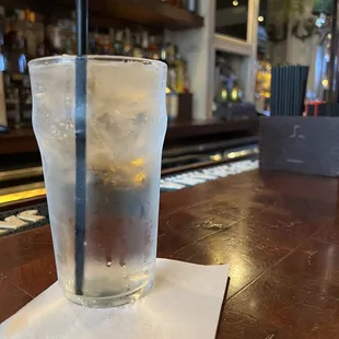 a glass of cold water on a bar