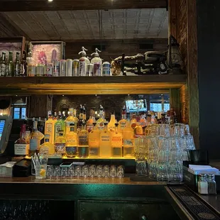 a bar with liquor bottles and glasses