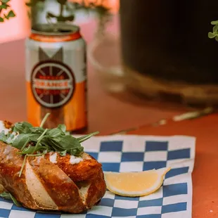 Breaded and fried Schreiner&apos;s sausage topped with lemon mayo and arugula.