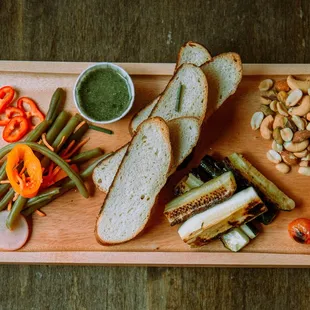 Try our Veggie Board! Seasonal roasted and pickled veggies, mixed nuts and house made herd pesto! Let us know if you&apos;re vegan!