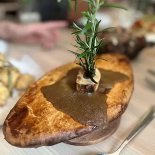 a piece of bread with a sprig of rosemary on top