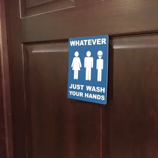 a bathroom door with a sign that says whatever just wash your hands
