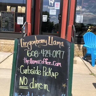 a chalkboard sign outside of a restaurant