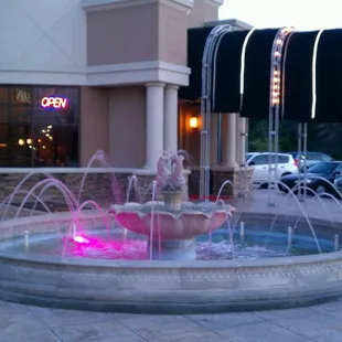 a fountain in front of a restaurant