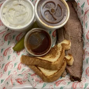 a sandwich, pickle, and sauce