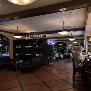 Bar/lounge space with dining room in the distance.