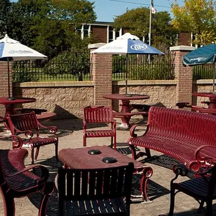 a patio with tables and chairs
