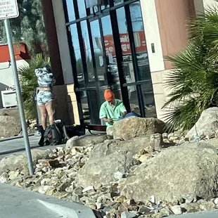 Homeless people in front of the entry door. Lins 75th Ave and Indian school..