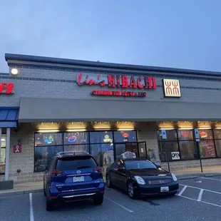 two cars parked in front of a restaurant