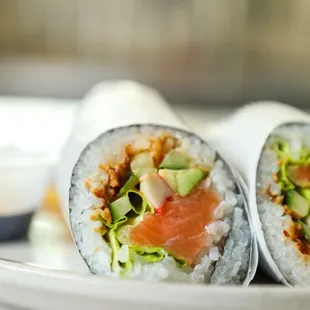 two sushi rolls on a plate