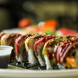 a plate of sushi with sauce