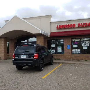 a car parked in front of a restaurant