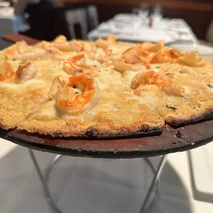 a pizza with shrimp and cheese on it