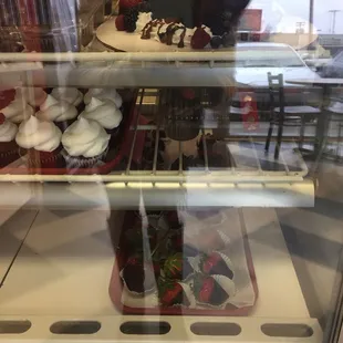 cupcakes and pastries in a display case