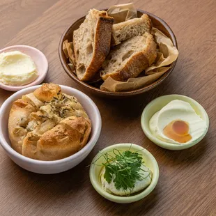 Our house made sourdough and focaccia with house cultured butter, eggplant and goat cheese spread and whipped ricotta with local honey.