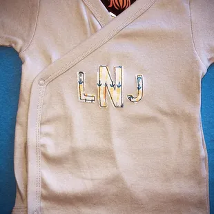 Embroidered baby onesie to shower the new mom with love.
