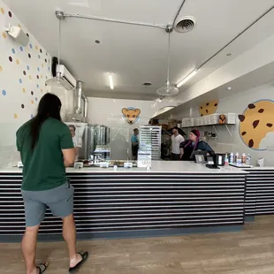 a woman standing at a counter