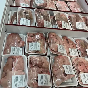 a display of meat in plastic containers