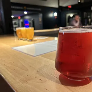 a glass of beer on a bar